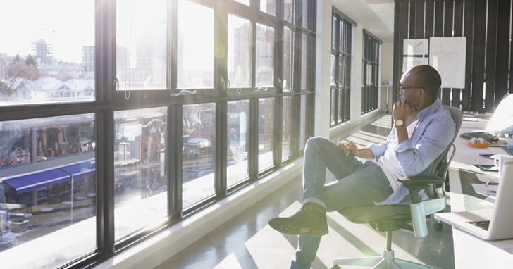 Man gazes out the window in deep thought